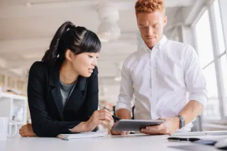 Business people looking at tablet